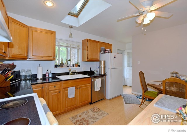 1405 Village Ln, Fort Collins, CO 80521 - kitchen with dishwasher, a sink, freestanding refrigerator, a skylight, and exhaust hood