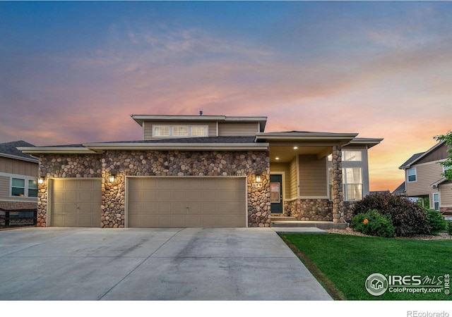 830 Corn Stalk Dr, Windsor, CO 80550 - prairie-style house featuring stone siding, concrete driveway, a garage, and a front yard