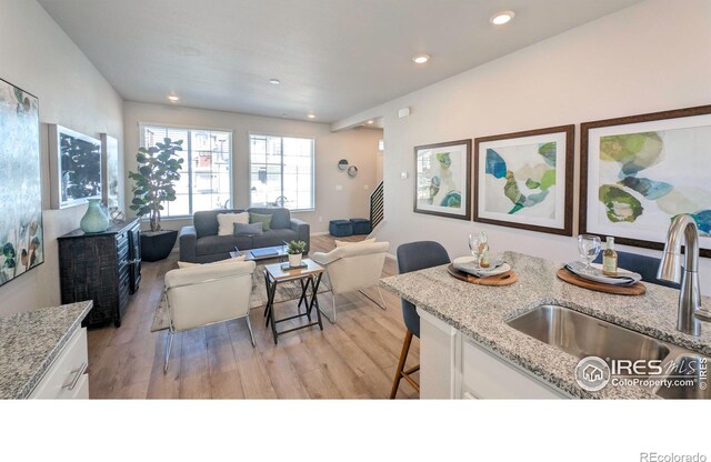 3356 Streamwood Dr, Johnstown, CO 80534 - living area with light wood-style flooring and recessed lighting