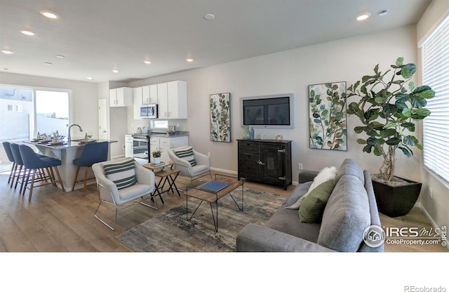 3356 Streamwood Dr, Johnstown, CO 80534 - living room featuring wood finished floors and recessed lighting