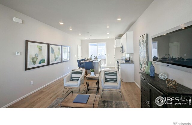 3356 Streamwood Dr, Johnstown, CO 80534 - living room featuring light wood finished floors and recessed lighting