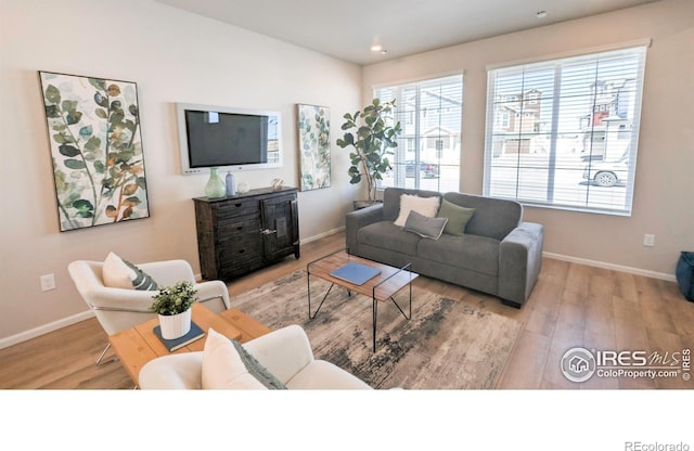 3356 Streamwood Dr, Johnstown, CO 80534 - living area with wood finished floors and recessed lighting
