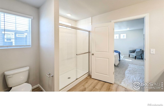 3356 Streamwood Dr, Johnstown, CO 80534 - ensuite bathroom featuring a stall shower and wood finished floors