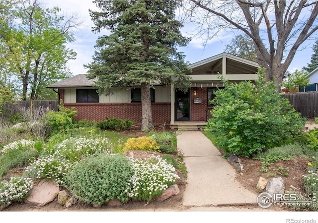 1110 Hartford Dr, Boulder, CO 80305 - view of front of home with brick siding, covered porch, and board and batten siding