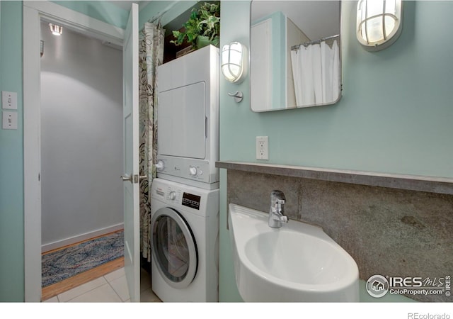1110 Hartford Dr, Boulder, CO 80305 - laundry room with stacked washer / drying machine and tile patterned flooring