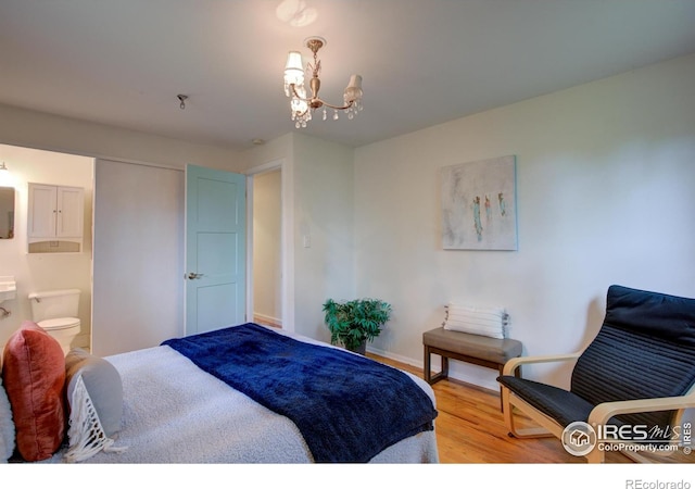 1110 Hartford Dr, Boulder, CO 80305 - bedroom with light wood finished floors, a chandelier, baseboards, and ensuite bathroom