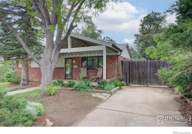 1110 Hartford Dr, Boulder, CO 80305 - view of front facade with brick siding and covered porch