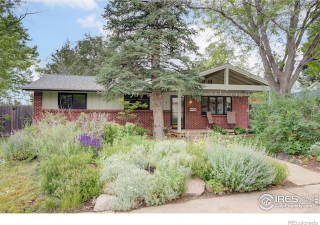 1110 Hartford Dr, Boulder, CO 80305 - view of front of property with brick siding, a porch, and board and batten siding