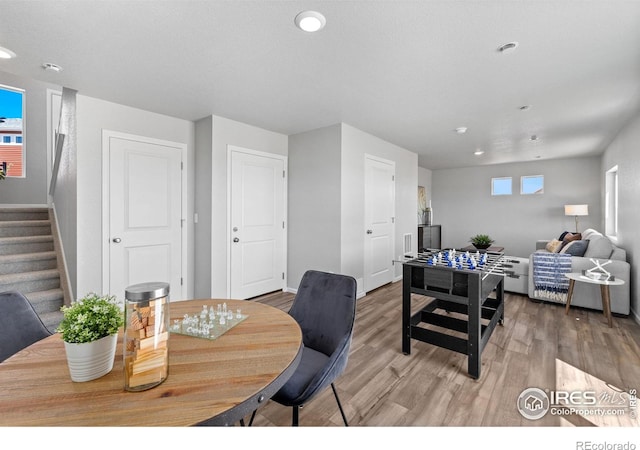 3364 Streamwood Dr, Johnstown, CO 80534 - dining space featuring stairs, light wood finished floors, and recessed lighting