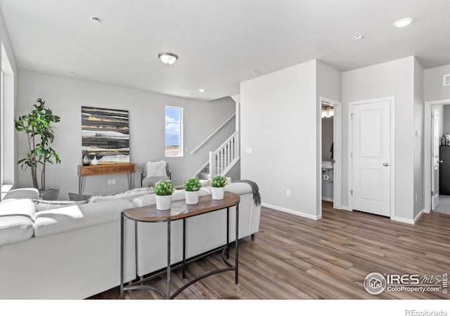 3364 Streamwood Dr, Johnstown, CO 80534 - living room with stairs, wood finished floors, and recessed lighting