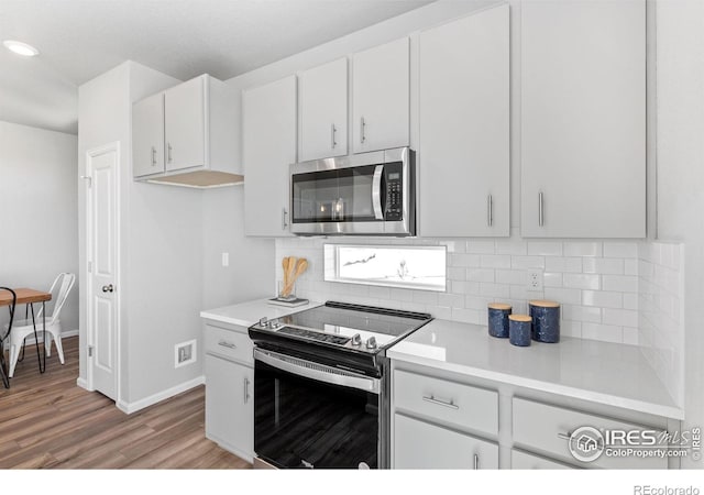 3364 Streamwood Dr, Johnstown, CO 80534 - kitchen with stainless steel appliances, decorative backsplash, light wood-style floors, and light countertops