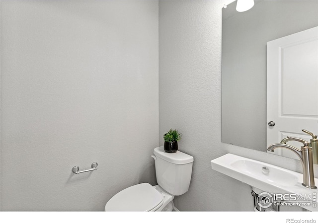 3364 Streamwood Dr, Johnstown, CO 80534 - half bathroom with a sink and toilet