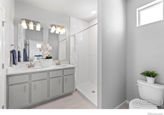 3364 Streamwood Dr, Johnstown, CO 80534 - full bathroom featuring a tile shower, double vanity, and tile patterned floors