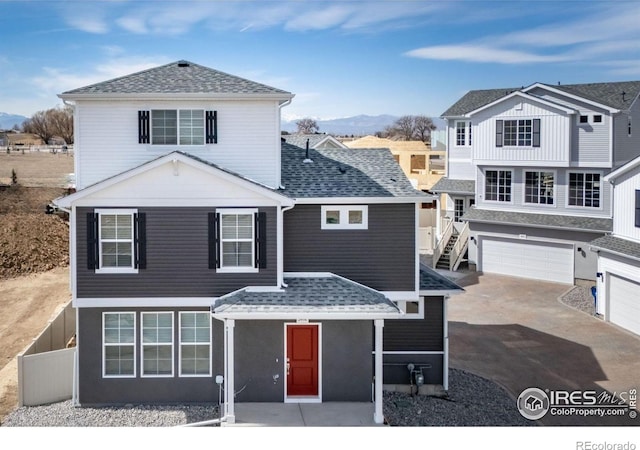 3364 Streamwood Dr, Johnstown, CO 80534 - traditional-style house with a mountain view, concrete driveway, an attached garage, and roof with shingles