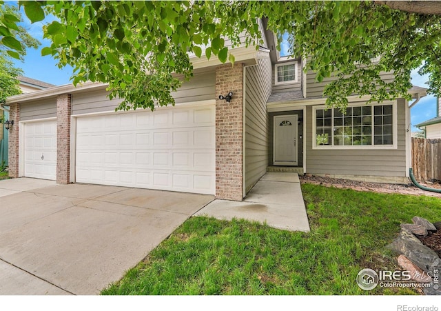 11740 Ivy St, Thornton, CO 80233 - view of front of property featuring brick siding, driveway, and an attached garage