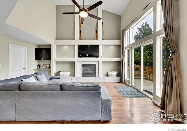 11740 Ivy St, Thornton, CO 80233 - living room with high vaulted ceiling, a ceiling fan, wood finished floors, and a fireplace