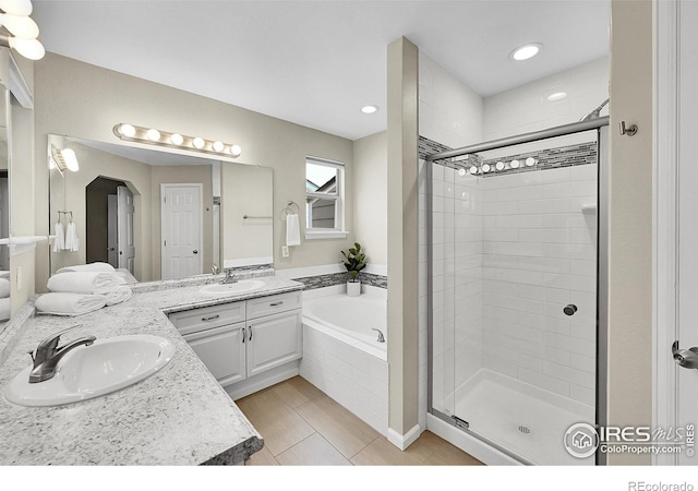 11740 Ivy St, Thornton, CO 80233 - bathroom with a stall shower, vanity, a garden tub, and recessed lighting