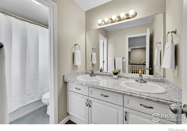 11740 Ivy St, Thornton, CO 80233 - bathroom featuring double vanity and toilet