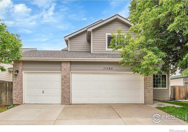 11740 Ivy St, Thornton, CO 80233 - traditional-style home featuring brick siding, a garage, concrete driveway, and a shingled roof