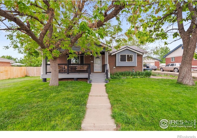 11385 Downing Dr, Northglenn, CO 80233 - view of front of house featuring covered porch and brick siding