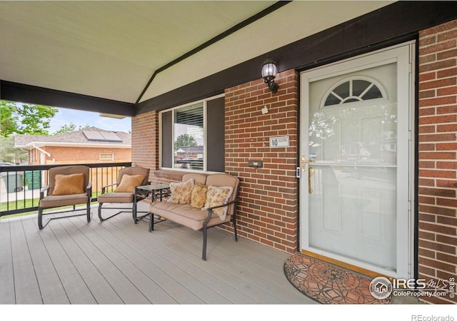 11385 Downing Dr, Northglenn, CO 80233 - doorway to property with brick siding and a porch