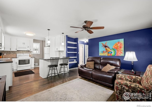 11385 Downing Dr, Northglenn, CO 80233 - living room with dark wood-style floors, ceiling fan, and baseboards