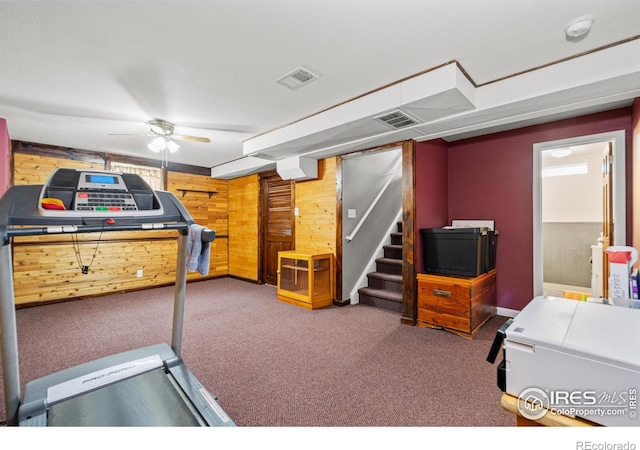 11385 Downing Dr, Northglenn, CO 80233 - workout room with wood walls, carpet flooring, and a ceiling fan