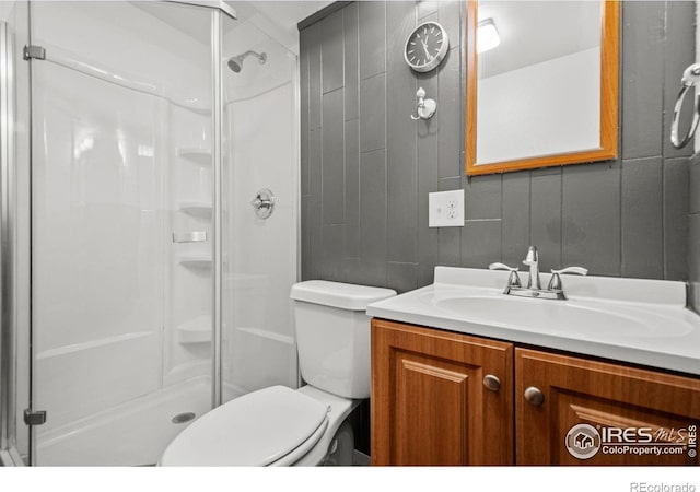 11385 Downing Dr, Northglenn, CO 80233 - full bathroom featuring a stall shower, vanity, and toilet