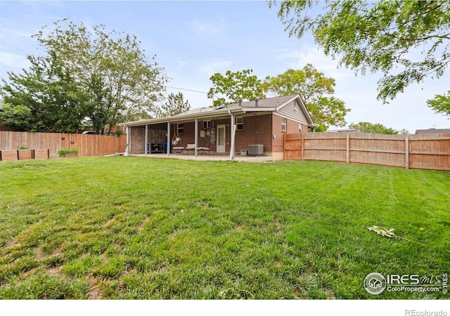 11385 Downing Dr, Northglenn, CO 80233 - rear view of house with a patio area, central air condition unit, and brick siding