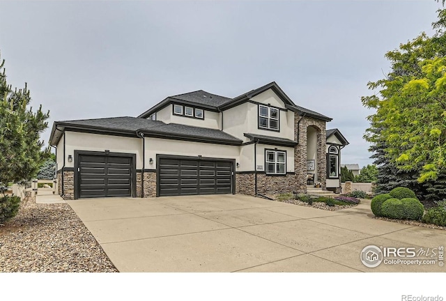 8839 Shetland Dr, Frederick, CO 80504 - view of front of home featuring stone siding, stucco siding, an attached garage, and concrete driveway