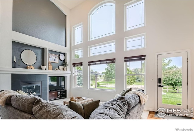 8839 Shetland Dr, Frederick, CO 80504 - living room with healthy amount of natural light, a towering ceiling, and a fireplace