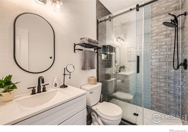 8839 Shetland Dr, Frederick, CO 80504 - bathroom featuring a shower stall, toilet, vanity, and a textured wall
