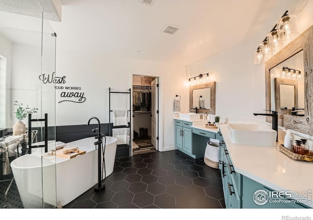8839 Shetland Dr, Frederick, CO 80504 - bathroom featuring vanity, a walk in closet, a shower stall, and a soaking tub