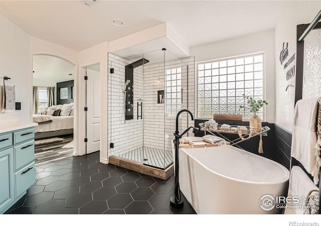 8839 Shetland Dr, Frederick, CO 80504 - ensuite bathroom featuring plenty of natural light, a soaking tub, a stall shower, tile patterned floors, and recessed lighting