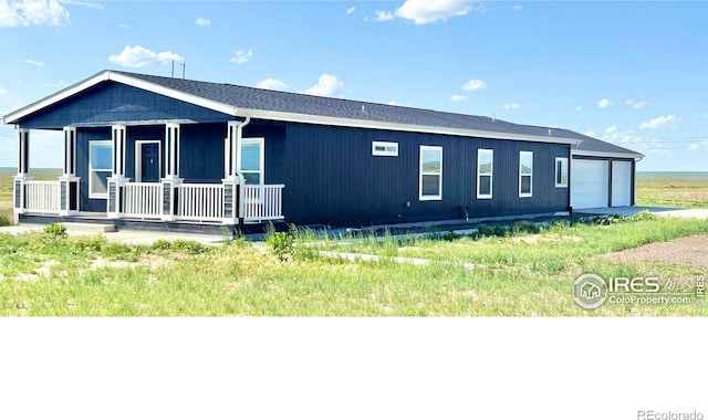 44502 County Road 68, Briggsdale, CO 80611 - view of front of home featuring covered porch and an attached garage