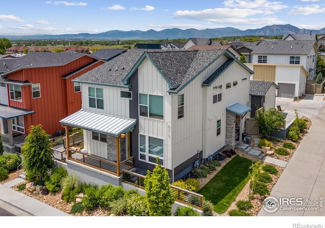 876 Cimarron Dr Unit B, Lafayette, CO 80026 - view of front facade featuring a standing seam roof, board and batten siding, a mountain view, metal roof, and a residential view