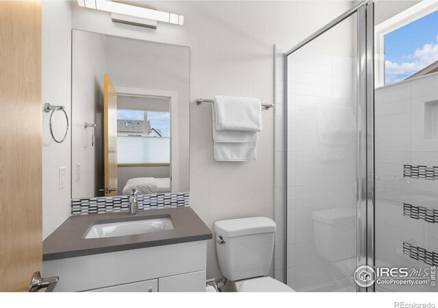 876 Cimarron Dr Unit B, Lafayette, CO 80026 - full bath featuring vanity, a stall shower, toilet, and ensuite bathroom