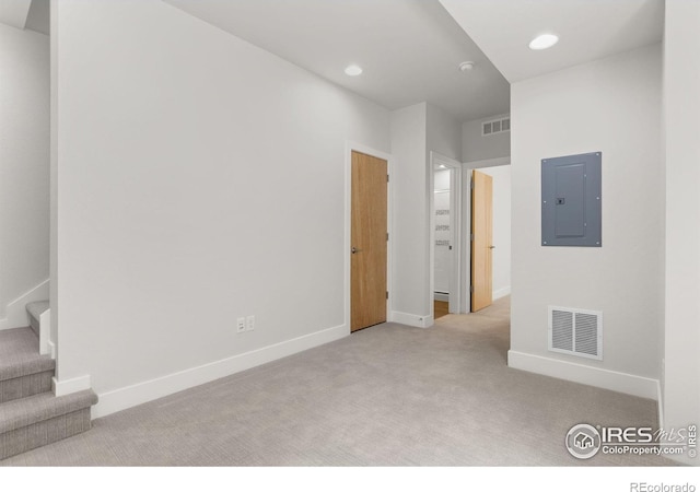 876 Cimarron Dr Unit B, Lafayette, CO 80026 - spare room with electric panel, carpet flooring, baseboards, stairway, and recessed lighting