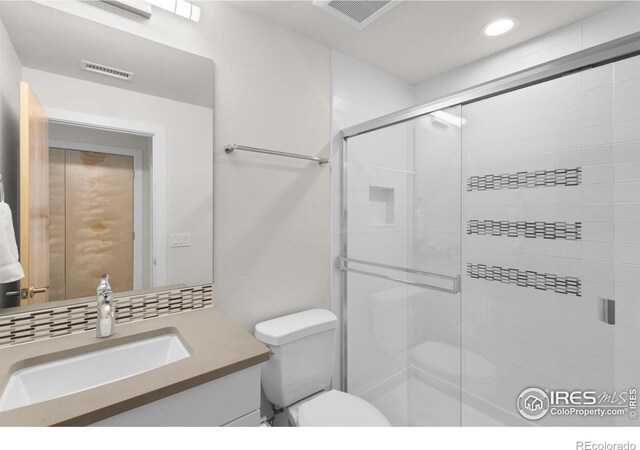 876 Cimarron Dr Unit B, Lafayette, CO 80026 - bathroom with a shower stall, vanity, toilet, and recessed lighting