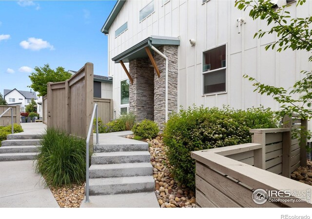 876 Cimarron Dr Unit B, Lafayette, CO 80026 - view of exterior entry featuring board and batten siding and stone siding