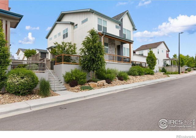 876 Cimarron Dr Unit B, Lafayette, CO 80026 - view of front facade with a residential view, stairs, and board and batten siding