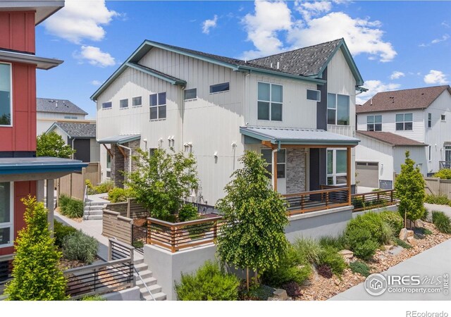 876 Cimarron Dr Unit B, Lafayette, CO 80026 - view of front of property with metal roof, a standing seam roof, a residential view, and stone siding