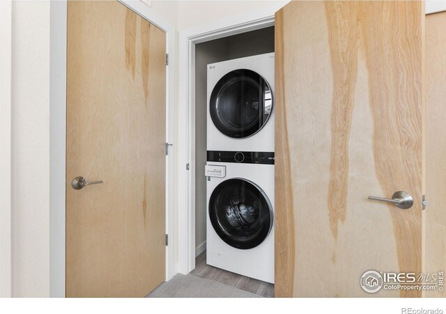 876 Cimarron Dr Unit B, Lafayette, CO 80026 - laundry room with stacked washer and clothes dryer and wood finished floors