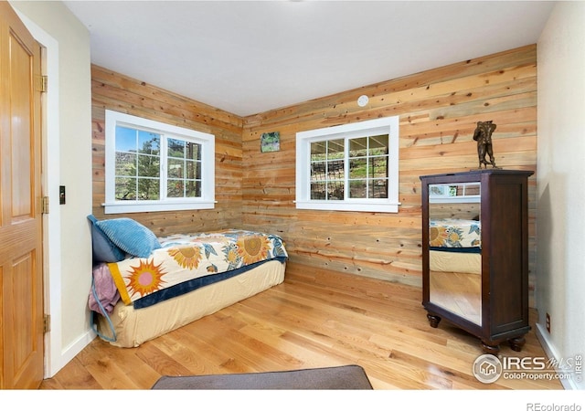 2507 Spencer Mountain Rd, Bellvue, CO 80512 - bedroom featuring multiple windows, wood finished floors, and wood walls
