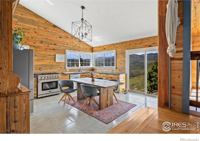2507 Spencer Mountain Rd, Bellvue, CO 80512 - dining area with wood walls, a chandelier, and high vaulted ceiling