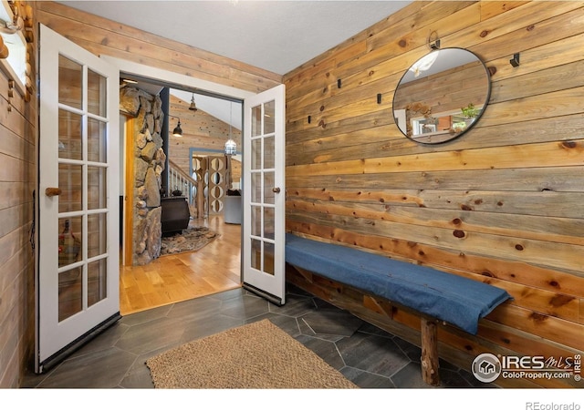 2507 Spencer Mountain Rd, Bellvue, CO 80512 - mudroom with french doors, wood walls, and a wood stove