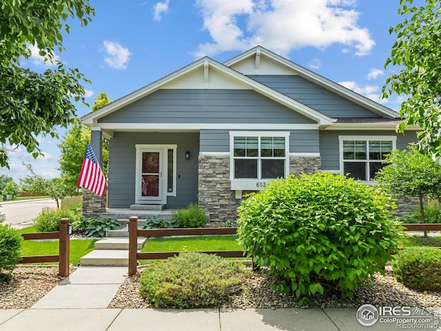 603 Summer Hawk Dr, Longmont, CO 80504 - view of front of property featuring stone siding and covered porch