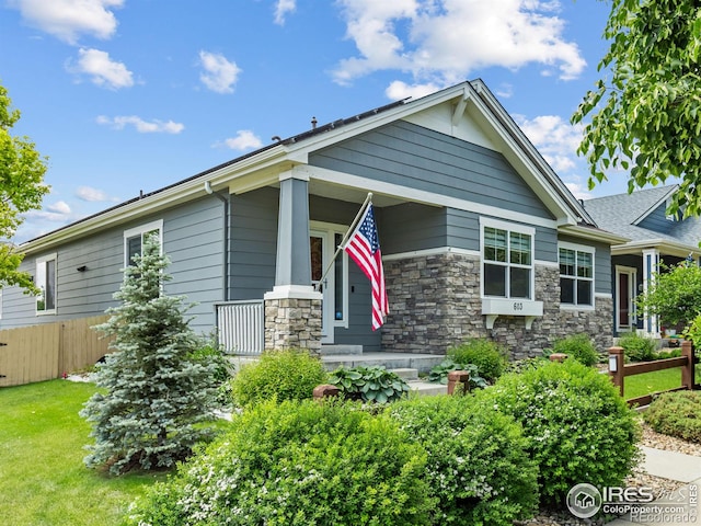 603 Summer Hawk Dr, Longmont, CO 80504 - craftsman-style home featuring covered porch and stone siding