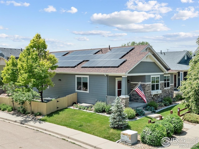 603 Summer Hawk Dr, Longmont, CO 80504 - view of front of house with roof with shingles, roof mounted solar panels, and a porch
