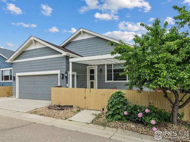603 Summer Hawk Dr, Longmont, CO 80504 - view of front of property with a fenced front yard, driveway, and a garage